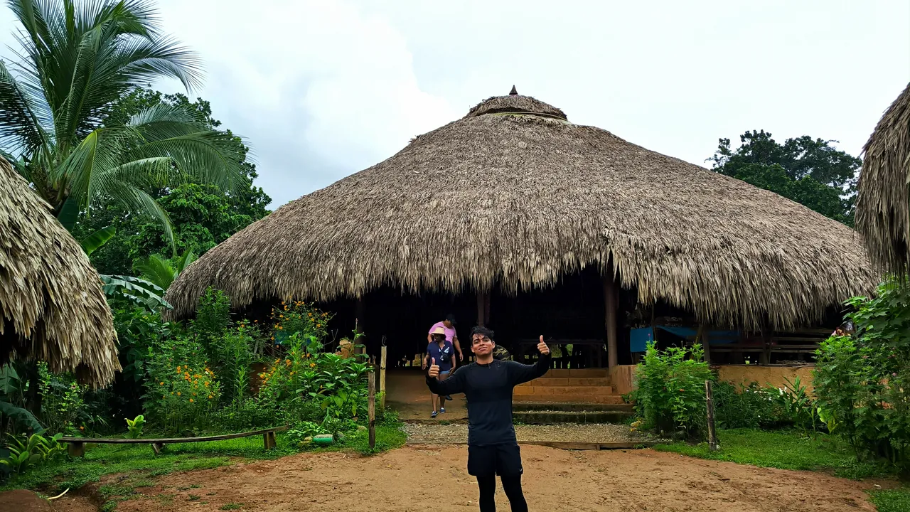Visitor outside a traditional community building